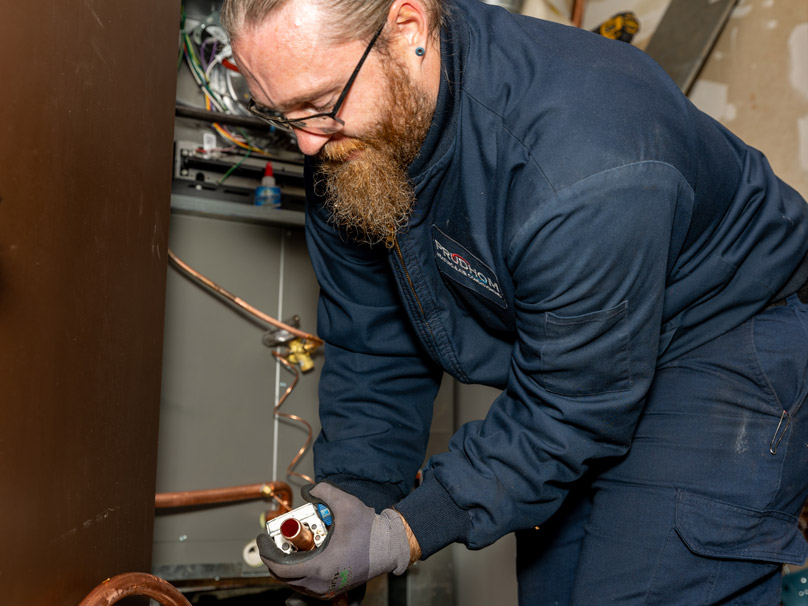 Prudhom tech servicing a furnace