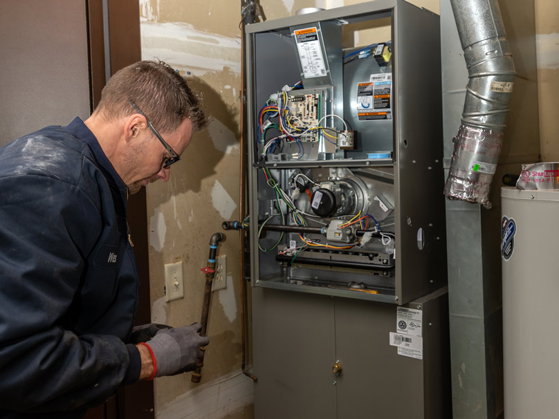 Prudhom tech repairing a furnace