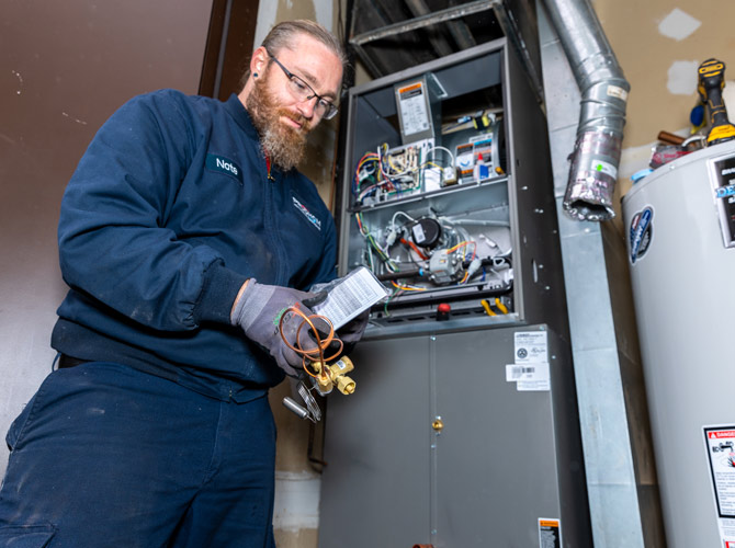 Prudhom tech servicing a furnace