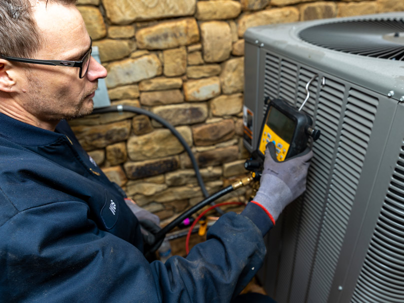 Prudhom tech repairing an air conditioner